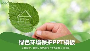 Ochrona środowiska szablon PPT z zielonym tle liści w ręku