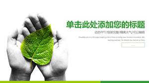 Ręka trzyma zielony liść ochrony środowiska PPT szablon